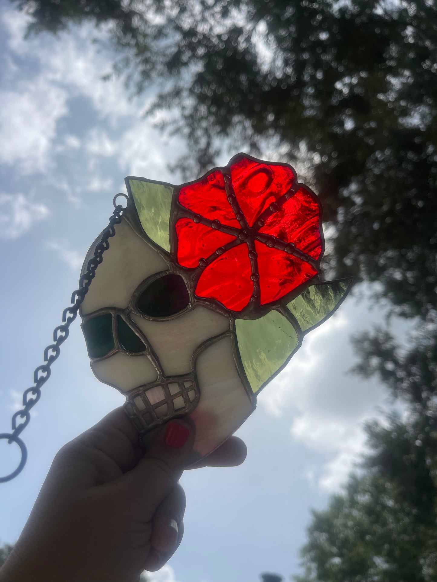 Skull with Iridescent White Glass and Red Flower